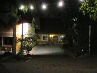 a house lit up at night with a patio at Appartement Weingut Schoberhof in Bad Gleichenberg