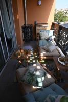 a room with couches and a table on a balcony at appartement carqueiranne le port in Carqueiranne