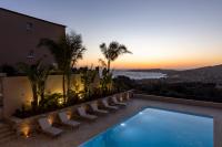 a villa with a swimming pool and a sunset at Résidence Omigna in Cargèse