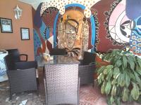 a restaurant with a mural of a man on the wall at Havre De Paix in Somone
