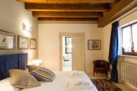 Posteľ alebo postele v izbe v ubytovaní Palazzo Fracastoro