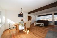 a dining room and living room with a table and chairs at Ferienwohnungen Wartbichler in Lofer