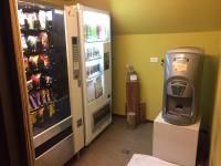 a coffee machine next to a refrigerator with drinks at Leofoo Resort Guanshi in Guanxi