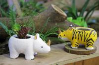 two toy animals sitting next to a potted plant at Leofoo Resort Guanshi in Guanxi
