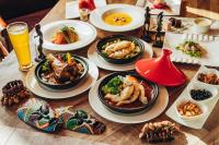 a wooden table with plates of food and drinks at Leofoo Resort Guanshi in Guanxi