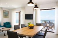 A television and/or entertainment centre at Villa Dafni - Infinite Sea Vistas with Private Pool