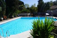 a swimming pool in a yard with plants at Complejo Rural Huerta Grande in Algeciras