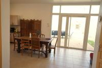 a kitchen and dining room with a table and chairs at Camping Arbre de Vie in Montagnac