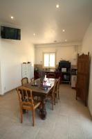 a kitchen with a table and chairs in a room at Camping Arbre de Vie in Montagnac