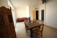 a dining room with a table and chairs and a couch at Camping Arbre de Vie in Montagnac
