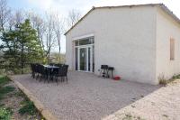 a patio with a table and chairs in front of a building at Camping Arbre de Vie in Montagnac