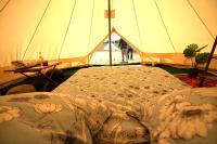 a tent with a bed in front of it at Camping Arbre de Vie in Montagnac