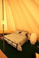 a bedroom with a bed in a tent at Camping Arbre de Vie in Montagnac
