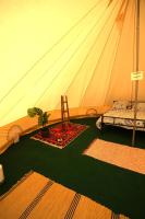 a tent with a chair and a plant in a room at Camping Arbre de Vie in Montagnac