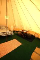 a tent with a bed and a table in it at Camping Arbre de Vie in Montagnac