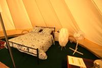 a bedroom with a bed in a tent at Camping Arbre de Vie in Montagnac