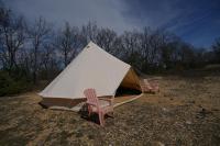 two chairs and a tent in a field at Camping Arbre de Vie in Montagnac