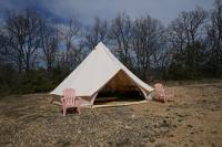 two chairs and a tent in a field at Camping Arbre de Vie in Montagnac
