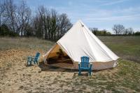 two chairs and a tent in a field at Camping Arbre de Vie in Montagnac