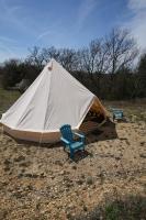 a large tent with two chairs and two chairs at Camping Arbre de Vie in Montagnac