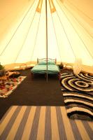 a room with a tent with a bed in it at Camping Arbre de Vie in Montagnac