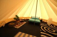 a tent with a bed and a chair in a room at Camping Arbre de Vie in Montagnac