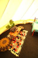 a room with a tent and a table and a rug at Camping Arbre de Vie in Montagnac