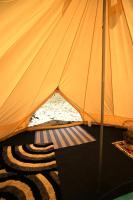 a tent with a rug in the middle at Camping Arbre de Vie in Montagnac