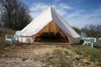 a tent with two chairs and a table at Camping Arbre de Vie in Montagnac
