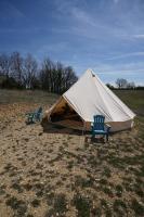 two chairs and a tent in a field at Camping Arbre de Vie in Montagnac