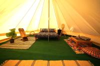 a tent with a couch and chairs and a table at Camping Arbre de Vie in Montagnac