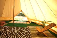 a tent with a pair of shoes in front of it at Camping Arbre de Vie in Montagnac
