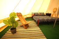a room with a tent with a bed and a plant at Camping Arbre de Vie in Montagnac