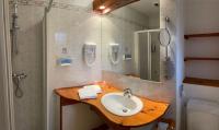 a bathroom with a sink and a shower at Hotel de Bourgogne in Saulieu