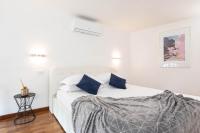 A bed or beds in a room at Campo dè Fiori Detached Apartment Eligio - Top Collection