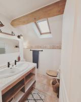 a bathroom with a sink and a skylight at La Ferme de Philomène - Gîte en Périgord Noir in Sainte-Foy-de-Belvès