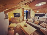 a living room with a couch and a table at La Ferme de Philomène - Gîte en Périgord Noir in Sainte-Foy-de-Belvès