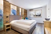 A bed or beds in a room at Apartments Pragser Wildsee Winklwiese