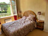 a bedroom with a large bed and a window at Mas des IRIS in Saint-Rémy-de-Provence
