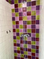 a shower with a colorful tiled wall in a bathroom at Mas des IRIS in Saint-Rémy-de-Provence