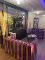 a lobby with two purple couches and a table at Hotel de l&#39;Europe in Dieppe