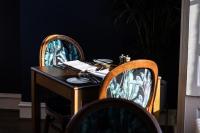 Un escritorio con dos sillas y una mesa con papeles encima. en Marshall Meadows Manor House, en Berwick-Upon-Tweed