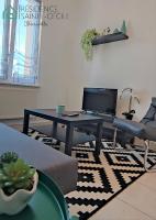 a living room with a table with a laptop on it at Résidence Sainte-Cécile in Thionville