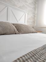 A bed or beds in a room at Second Home Arzúa apartamentos