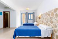 Łóżko lub łóżka w pokoju w obiekcie Hostal Marina