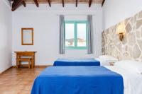 Łóżko lub łóżka w pokoju w obiekcie Hostal Marina