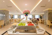 a buffet line with fruits and vegetables on display in a restaurant at Canary Gold Hotel Quy Nhơn - Beachfront - Iconic Location in Quy Nhon