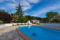 a swimming pool with chairs and a house at Au Temps Suspendu in Saint-Martin-dʼOydes