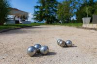 four metal balls on the ground in a driveway at Au Temps Suspendu in Saint-Martin-dʼOydes