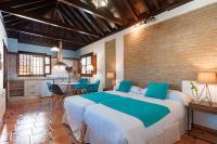 Posteľ alebo postele v izbe v ubytovaní SUITES CASA DE LAS COLUMNAS